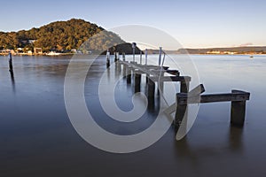 wharf in long exposure water near a mountain at ettalong in australia