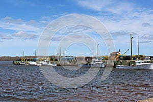 A wharf in Wallace Nova Scotia with lobster fishing boats getting ready to set traps for the season