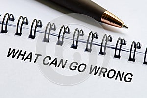 What can go wrong text on white notepad. Business or auditing concept photo