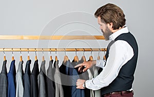 What design is better. businessman. confident tailor designing male jacket. handsome sartor with tape measure. male photo