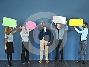 What did I get myself in to. Shot of a man looking overwhelmed as people hold up speech bubbles around him.