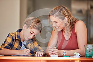 What did you learn at school today. a young woman helping her son with his homework at home.