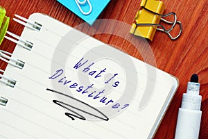 What Is Divestiture? sign on the piece of paper