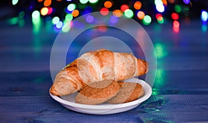 What do kids around world leave for Santa. Croissant and oat cookies on white plate. Winter holiday tradition. Sweets