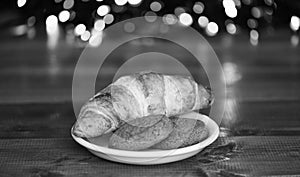 What do kids around world leave for Santa. Croissant and oat cookies on white plate. Winter holiday tradition. Sweets