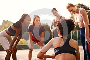 What do you all think. a diverse group of friends getting ready to play a game of basketball together during the day.