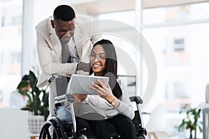 What do you think. Cropped shot of an attractive young businesswoman in a wheelchair talking to the male colleague