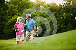 What do you think of this golf course. a mature couple on a golf course.