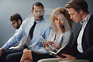 What do you think. a group of businesspeople waiting in line for a job interview.