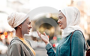 What do you think we should do next. an attractive young woman wearing a hijab and talking with her female friend while