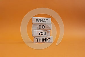 What do you think symbol. Wooden blocks with words What do you think. Beautiful orange background. Business and What do you think