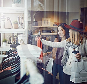 What do you think. two best friends out shopping in a clothing store.