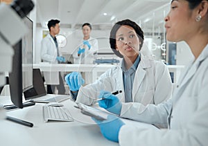 What do you think. two scientists helping one another in the lab.