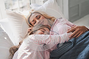 What are they dreaming about? Mother and daughter keeping eyes c