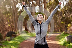 What a good run that was. a fit young woman looking cheerful while out for a run.