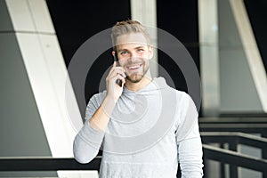 What great news. Man with beard call smartphone urban background. Guy happy smile use smartphone to communicate friends