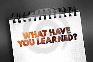 What Have You Learned question text quote on notepad, concept background