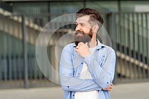 What is on his mind. Pensive hipster thinking pleasant thoughts. Man bearded hipster urban background. Regular walk in