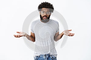 So what, I not care. Portrait of unbothered, indifferent confident african american man with beard and curly hair