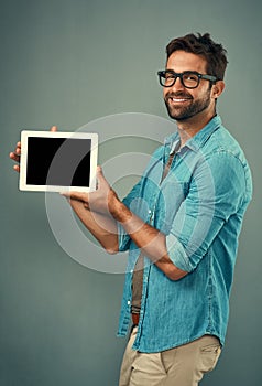 This is what I wanted to show you. Studio portrait of a handsome young man holding a digital tablet with a blank screen