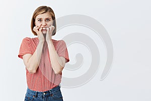 What if someone will knew my dirty secrets. Portrait of stunned anxious european woman with blond short haircut, biting