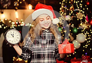 What is inside. Little girl in red hat. Holiday present. Happy new year. Gift fot you. Elf child. Xmas tree. Holiday