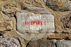 What inspires you symbol. Concept words What inspires you on beautiful big stone on stone wall. Beautiful stone wall background.