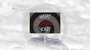 What inspires you symbol. Concept words What inspires you on beautiful black chalk blackboard. Beautiful snow background. Business