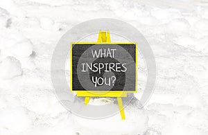 What inspires you symbol. Concept words What inspires you on beautiful black chalk blackboard. Beautiful snow background. Business