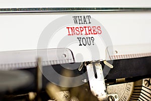 What inspires you symbol. Concept words What inspires you typed on beautiful retro old typewriter. Beautiful white background.