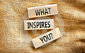 What inspires you symbol. Concept words What inspires you on wooden block. Beautiful canvas table canvas background. Business