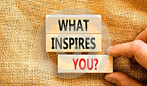 What inspires you symbol. Concept words What inspires you on wooden block. Beautiful canvas table canvas background. Businessman