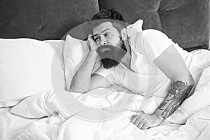 What a long night. Sleep disorders concept. Man bearded hipster having problems with sleep. Guy lying in bed try to