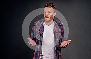 So what. Portrait of confused unaware good-looking redhead male with bristle, shrugging with raised palms staring uncertain over