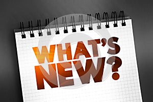 What's New question text on notepad, concept background