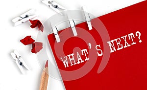 WHAT`S NEXT text on the red paper with office tools on white background photo