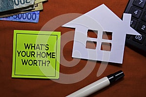 What`s Your Home Worth? on sticky Notes  on office desk.