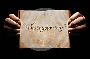 What`s your story? hands holding an open book background