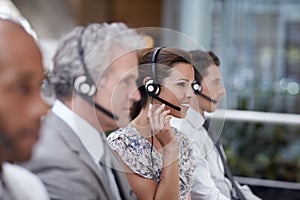 What seems to be the problem. Profile shot of an attractive customer service representative talking into a headset.