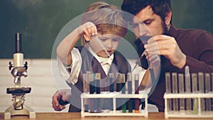 What is taught in chemistry. Teacher teaches a student to use a microscope. Science and education concept. Little