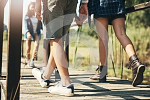 What will nature teach us today. Shot of a group of unrecognisable teenagers walking through nature together at summer