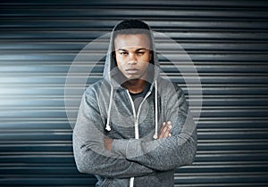 What will you achieve today. Portrait of a sporty young man standing with his arms crossed against a grey background.