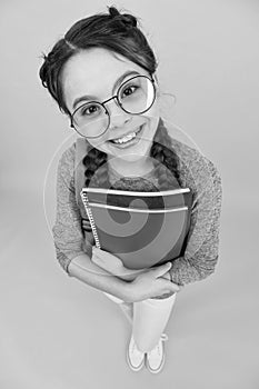 What would you like to read. Happy library reader yellow background. Little girl hold library books. Smart bookworm