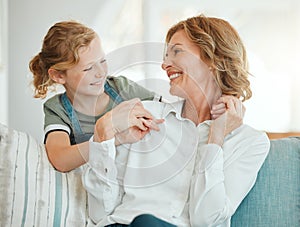 What you doing grandma. an adorable little girl hugging her grandmother during a day at home.