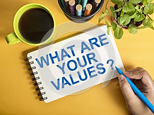 What are your core values, text words typography written on book against yellow background, life and business motivational