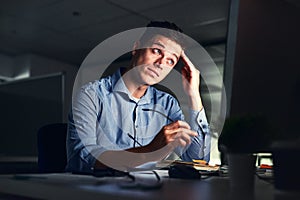 Whatever comes my way, I will still complete the deadline. Cropped shot of a young attractive businessman working late