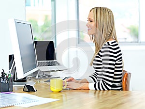 Whatever you choose to do today, make it good. Shot of a beautiful young woman working at her office desk.