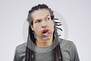 Whats fun about being normal. Studio shot of a young man making a funny face against a gray background.