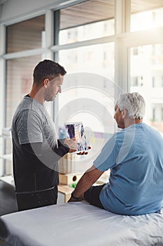 This is whats happening inside your body. a young male physiotherapist assisting a senior patient in recovery.