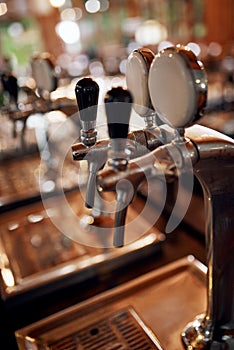 Whats on tap today. Closeup of a couple of beer taps standing and waiting to be used inside of a beer brewery during the